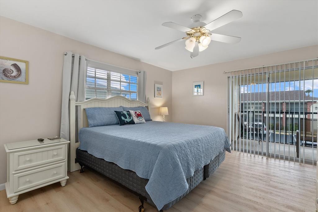 1531 Placida Road, Unit 204 Englewood, FL 34223 - Photo 17 of 47 a bedroom with a bed and a chandelier