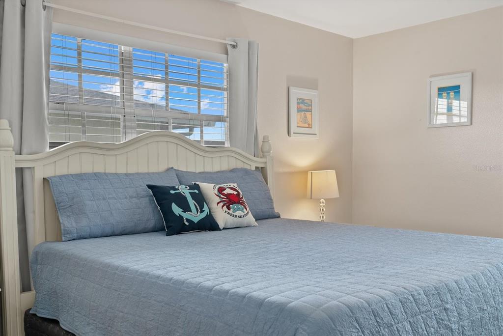 1531 Placida Road, Unit 204 Englewood, FL 34223 - Photo 19 of 47 a bed sitting in a bedroom next to a window