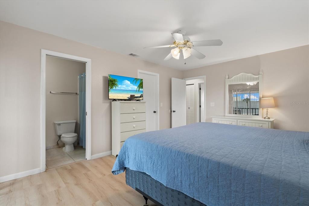 1531 Placida Road, Unit 204 Englewood, FL 34223 - Photo 21 of 47 a bedroom with a bed and a chandelier