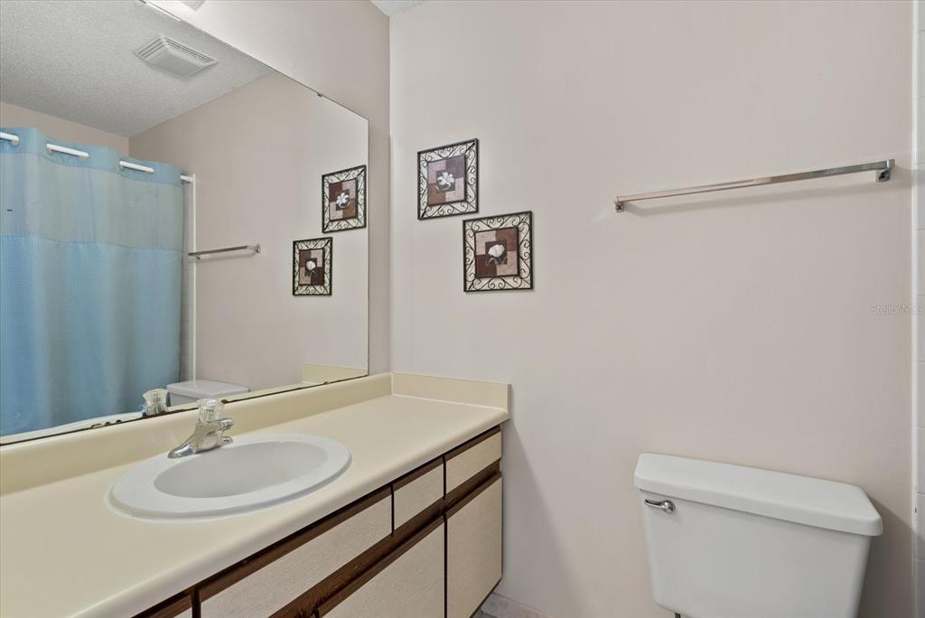 1531 Placida Road, Unit 204 Englewood, FL 34223 - Photo 22 of 47 a bathroom with a granite countertop sink toilet and a mirror
