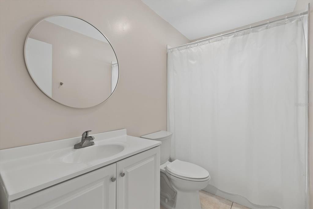 1531 Placida Road, Unit 204 Englewood, FL 34223 - Photo 24 of 47 a bathroom with a sink a toilet and a mirror