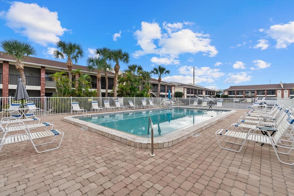 1531 Placida Road, Unit 204 Englewood, FL 34223 - Photo 27 of 47 a view of a swimming pool with outdoor seating