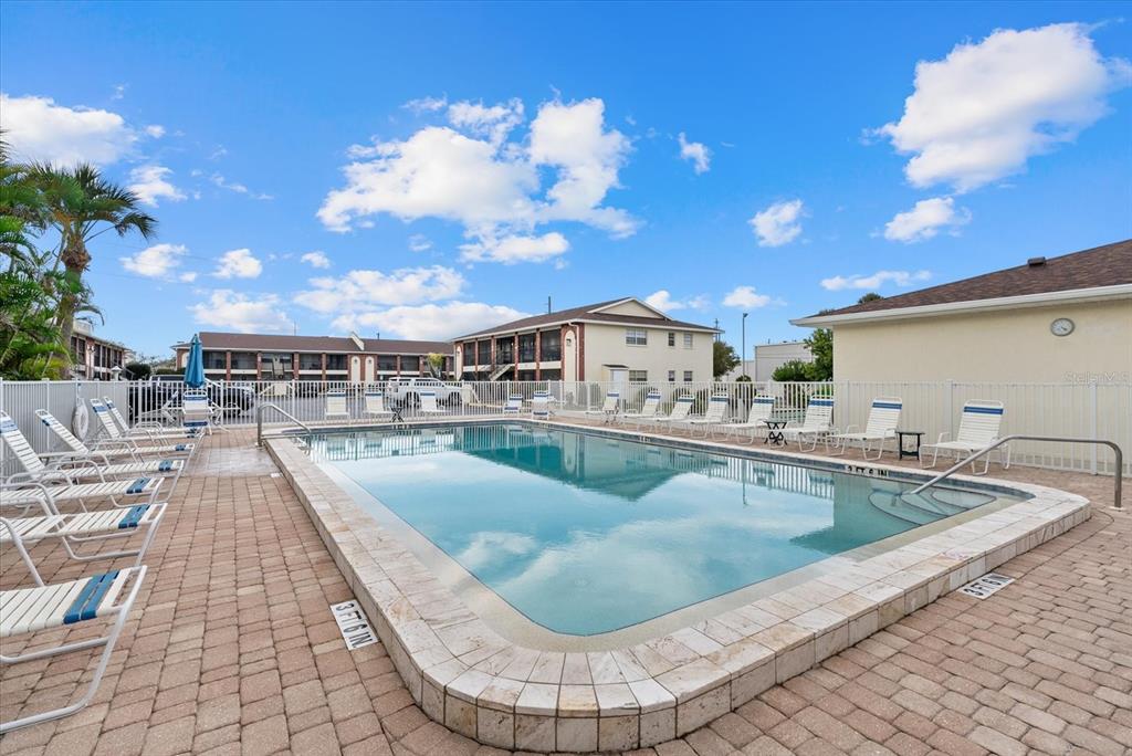1531 Placida Road, Unit 204 Englewood, FL 34223 - Photo 28 of 47 a view of a swimming pool with a lounge chair