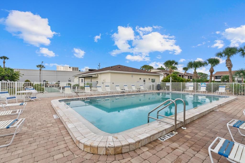 1531 Placida Road, Unit 204 Englewood, FL 34223 - Photo 29 of 47 a view of a swimming pool with a lounge chair