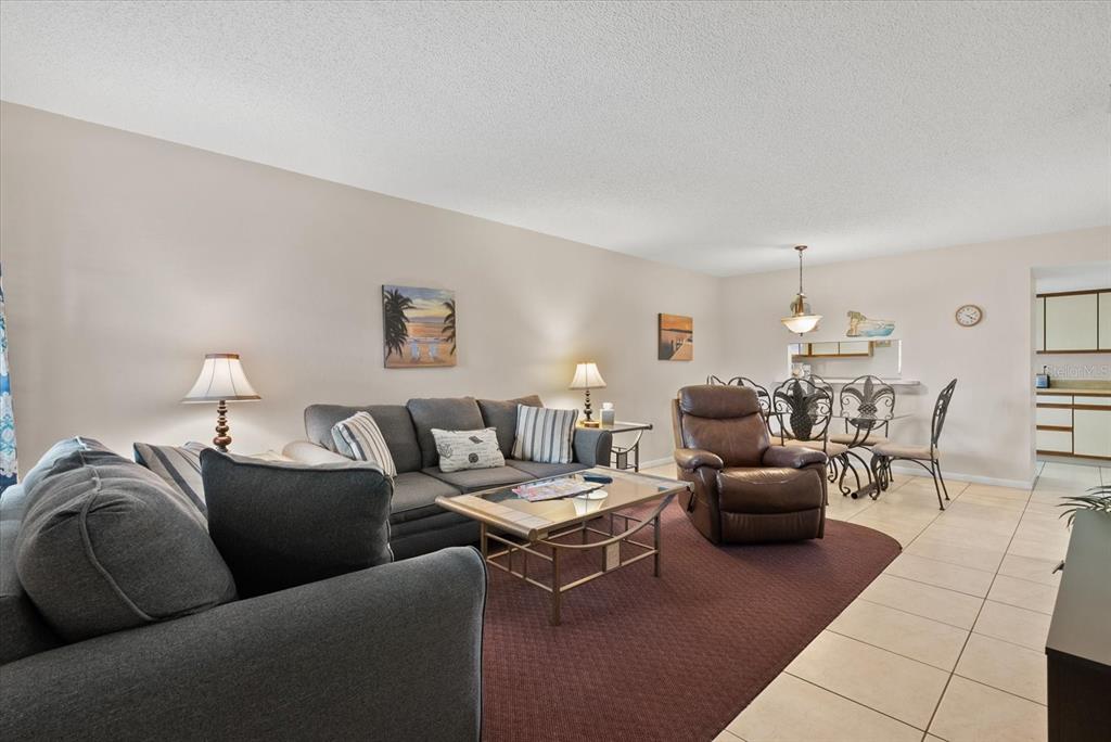 1531 Placida Road, Unit 204 Englewood, FL 34223 - Photo 3 of 47 a living room with furniture and a chandelier