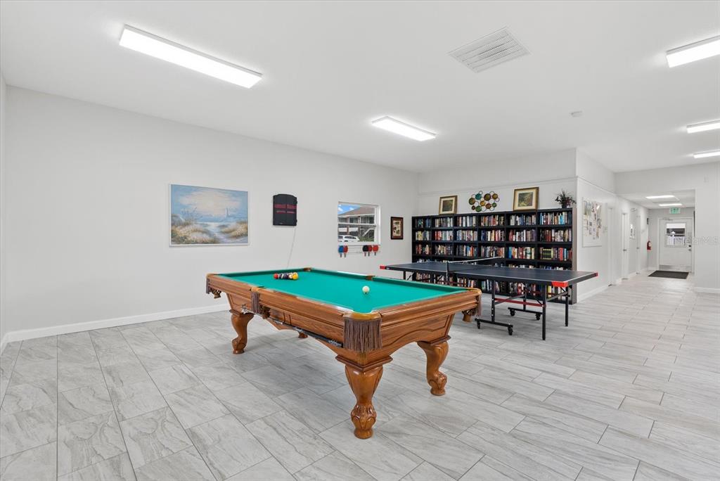 1531 Placida Road, Unit 204 Englewood, FL 34223 - Photo 33 of 47 a room with furniture and a book shelf