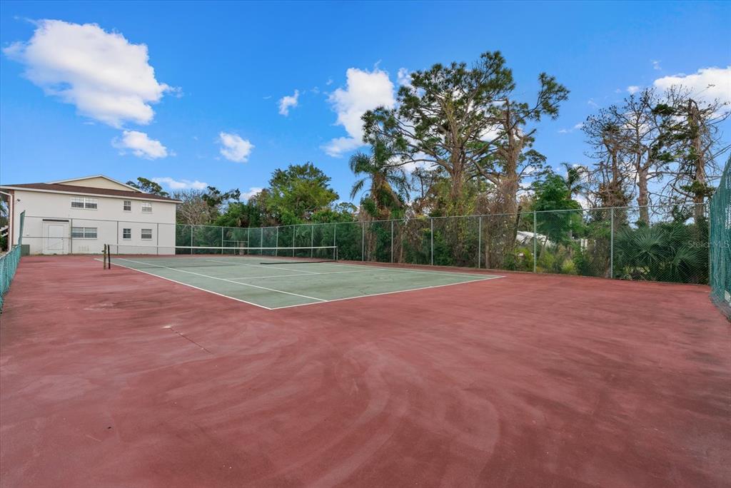 1531 Placida Road, Unit 204 Englewood, FL 34223 - Photo 34 of 47 a view of a field with trees in the background