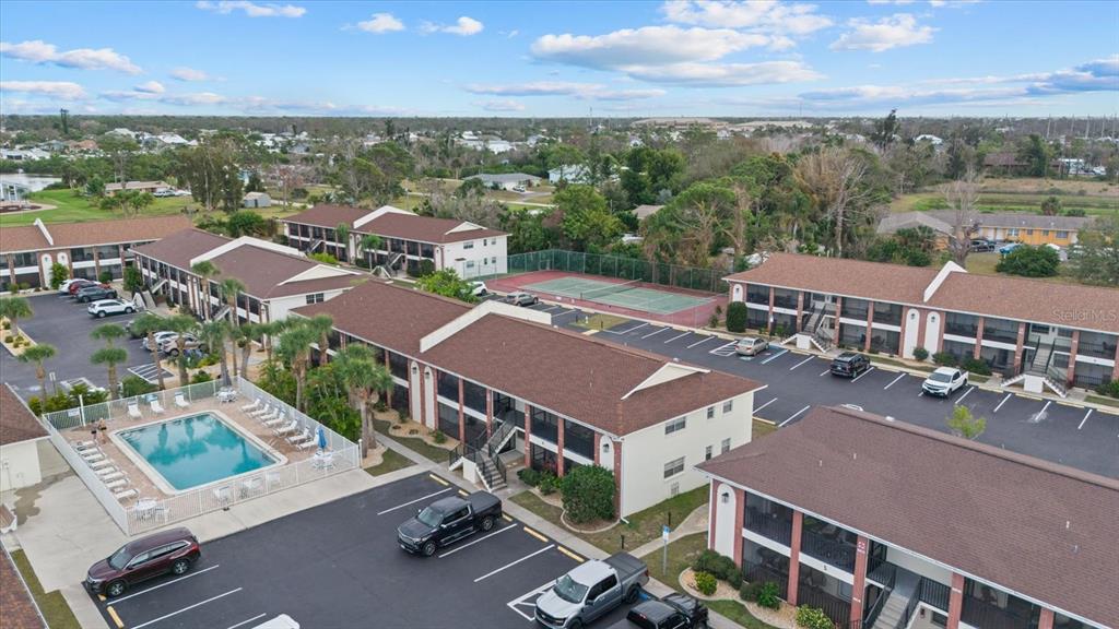 1531 Placida Road, Unit 204 Englewood, FL 34223 - Photo 45 of 47 an aerial view of multiple houses with a yard