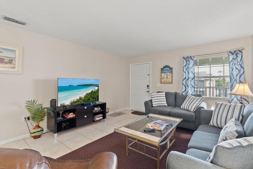 1531 Placida Road, Unit 204 Englewood, FL 34223 - Photo 5 of 47 a living room with furniture and a flat screen tv