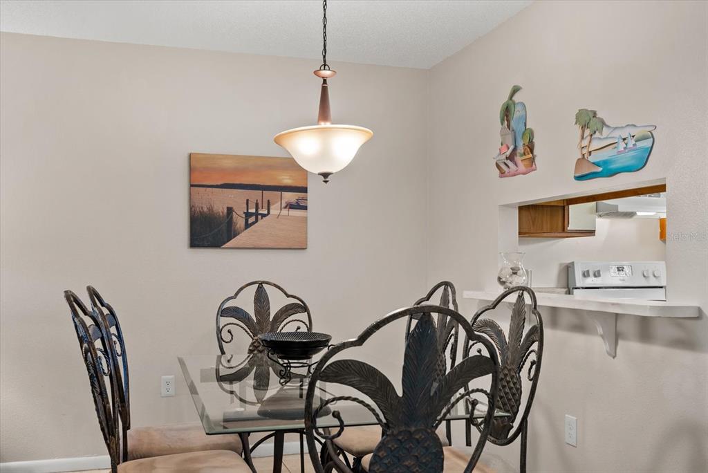 1531 Placida Road, Unit 204 Englewood, FL 34223 - Photo 8 of 47 a view of a dining room with furniture and chandelier