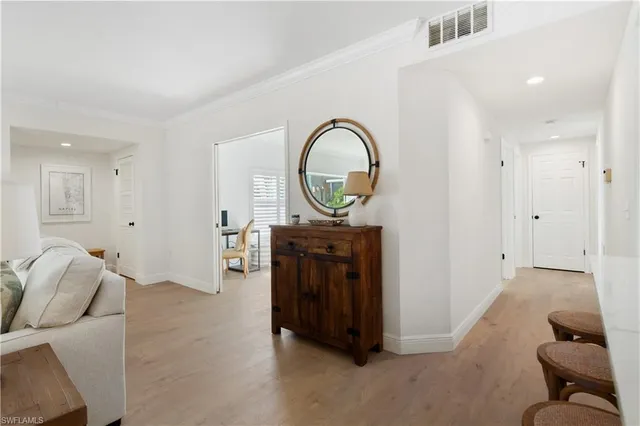 a view of a livingroom with furniture and a entryway