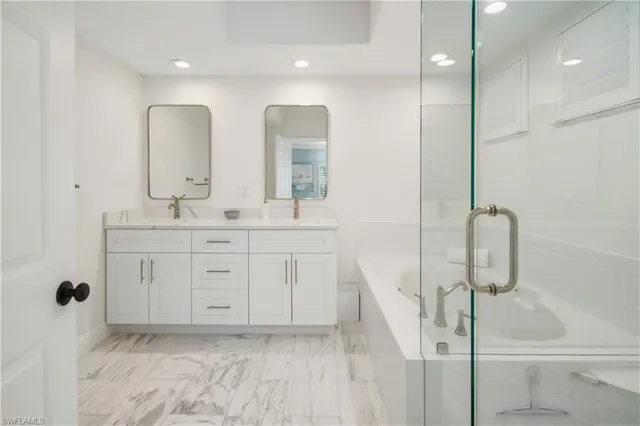 a bathroom with a double vanity sink a mirror and shower