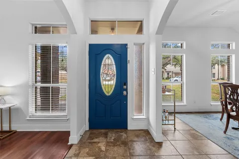 a view of a entryway of a house and wooden floor