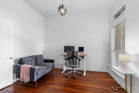 a view of a livingroom with workspace and a couch