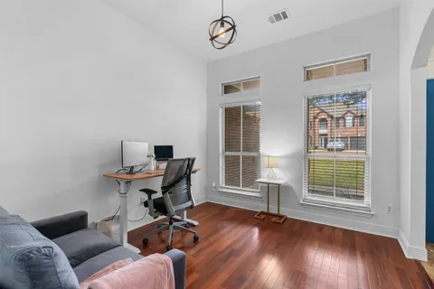 a work room with furniture and wooden floor