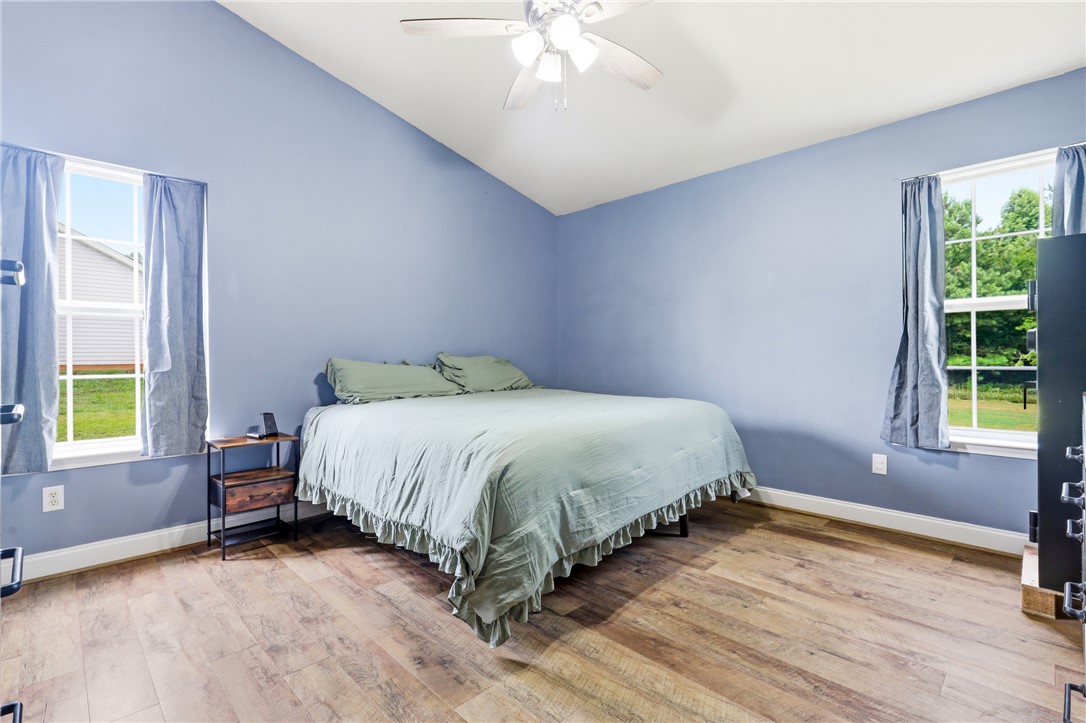 105 Lacy Lane Anderson, SC 29621 - Photo 9 of 16 A restful bedroom offers vaulted ceilings and durable wood flooring.