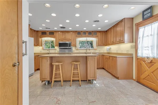 a kitchen with stainless steel appliances granite countertop wooden cabinets a sink and a stove