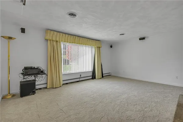 a view of an empty room with a fireplace