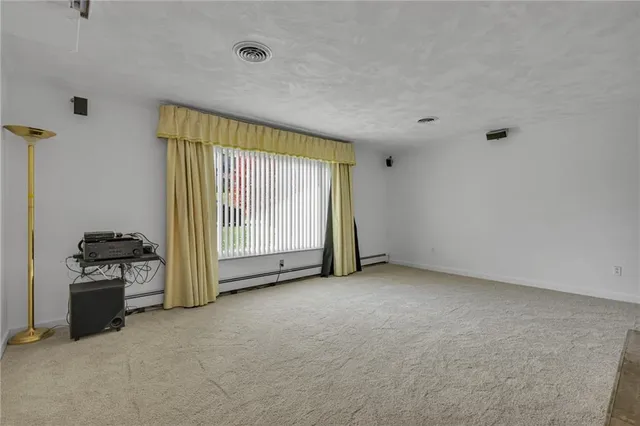 a view of an empty room with a fireplace