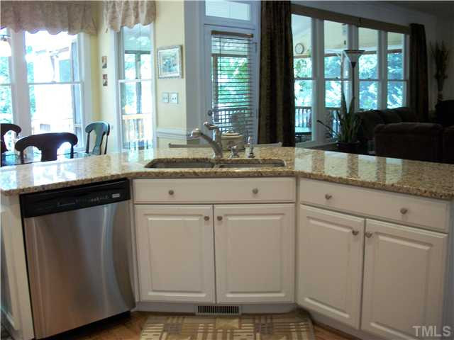 5209 Coffee Tree Drive Raleigh, NC 27613 - Photo 6 of 25 the large kitchen island has a double sink and bar stool area Kitchen