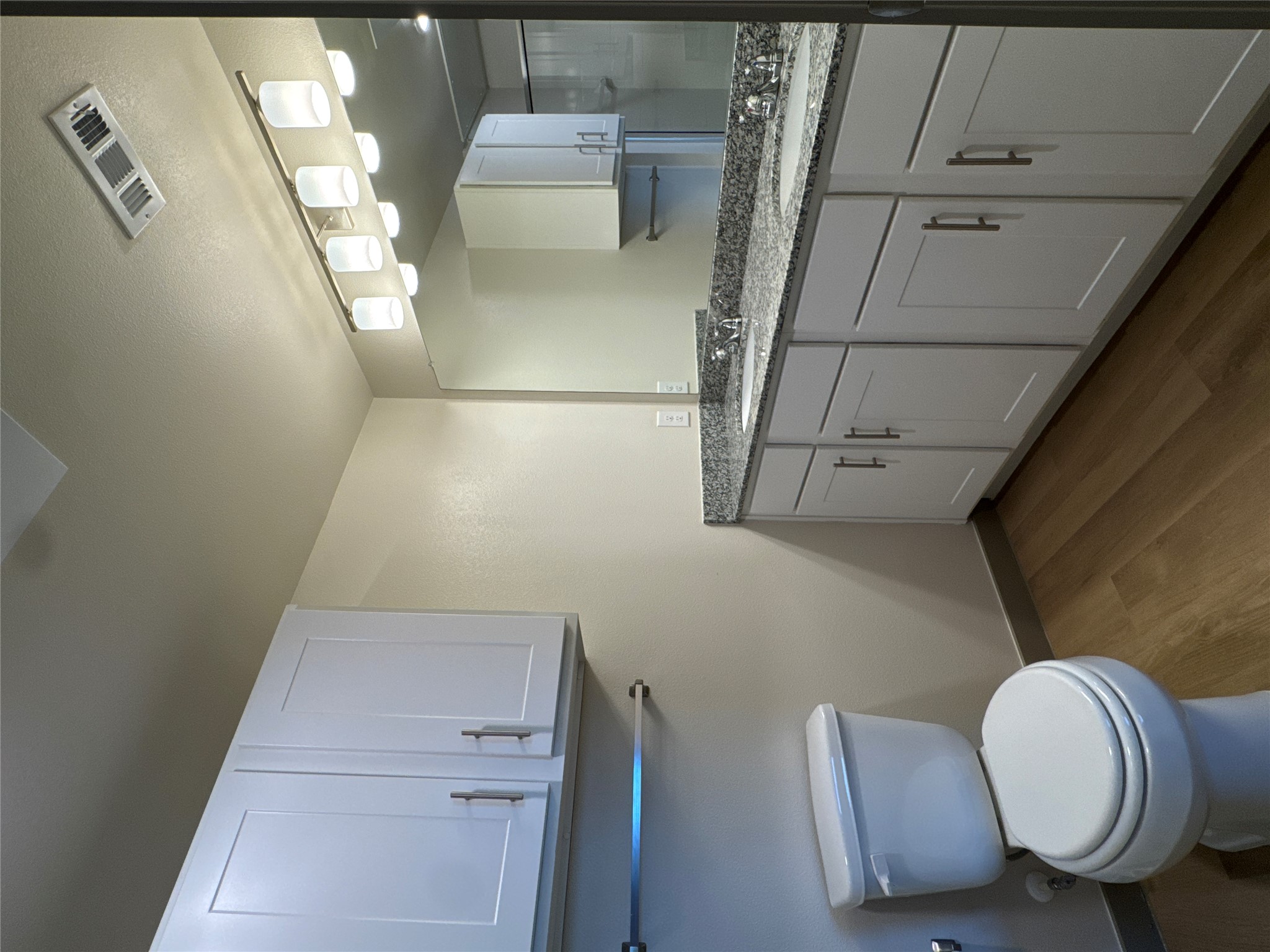 691 Union Chapel Road, Unit B2 Cedar Creek, TX 78612 - Photo 10 of 26 a bathroom with a granite countertop toilet sink and mirror