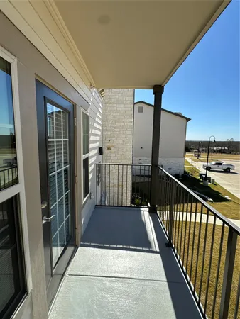 a view of a balcony and trees