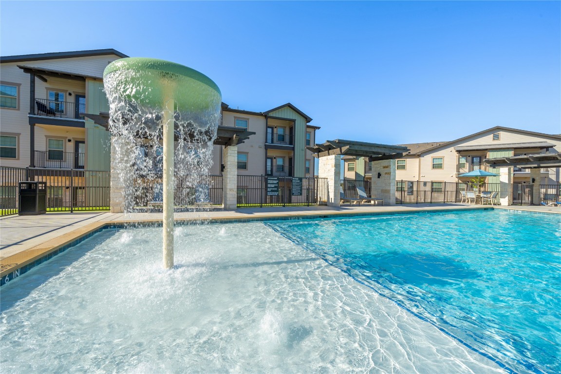 691 Union Chapel Road, Unit B2 Cedar Creek, TX 78612 - Photo 2 of 26 Community pool featuring a patio