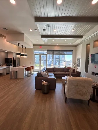 a living room with furniture and kitchen view