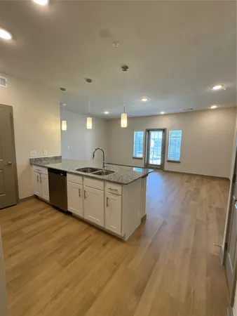 a room with a chandelier furniture and a wooden floor