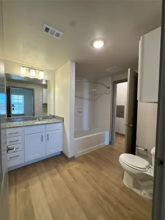 a large kitchen with stainless steel appliances granite countertop a large counter top a sink and a stove