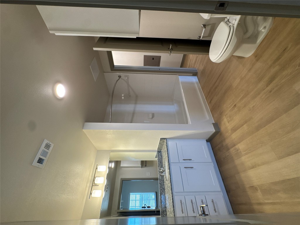 691 Union Chapel Road, Unit B2 Cedar Creek, TX 78612 - Photo 4 of 26 Bathroom featuring vanity, bathtub / shower combination, and light wood-style floors