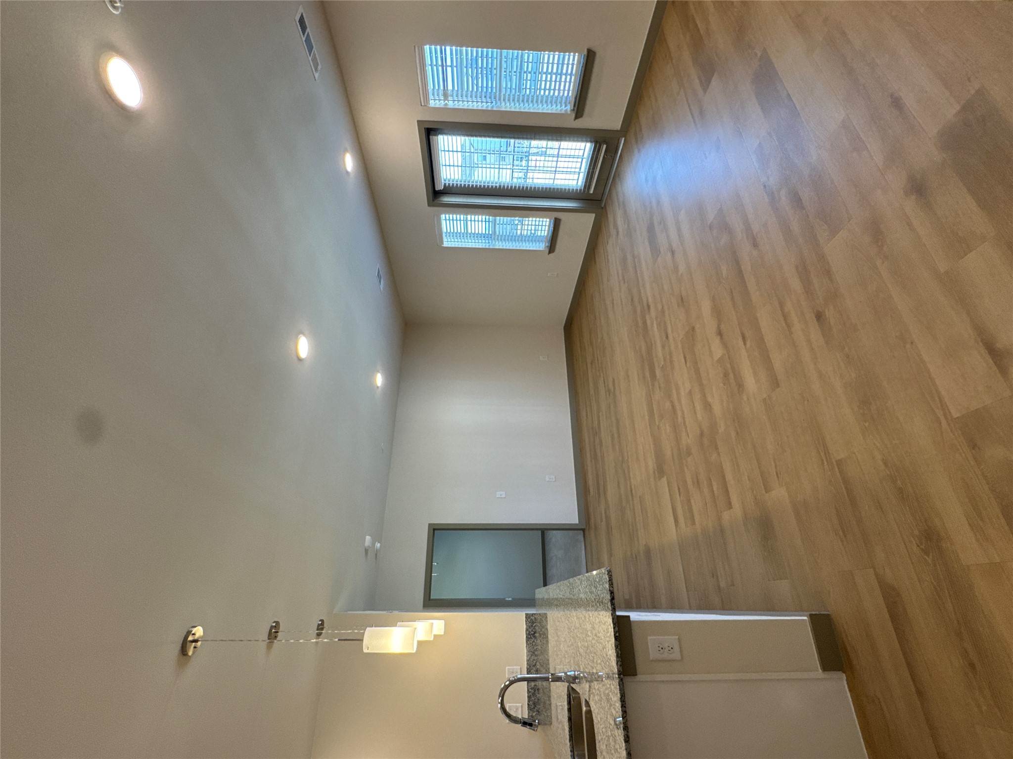 691 Union Chapel Road, Unit B2 Cedar Creek, TX 78612 - Photo 7 of 26 an empty room with wooden floor and windows