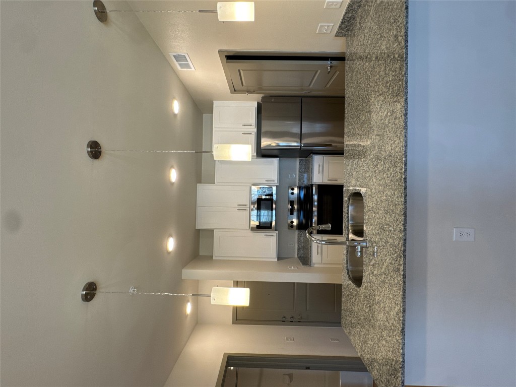 691 Union Chapel Road, Unit B2 Cedar Creek, TX 78612 - Photo 8 of 26 Kitchen with hanging light fixtures, appliances with stainless steel finishes, white cabinetry, stone counters, and recessed lighting