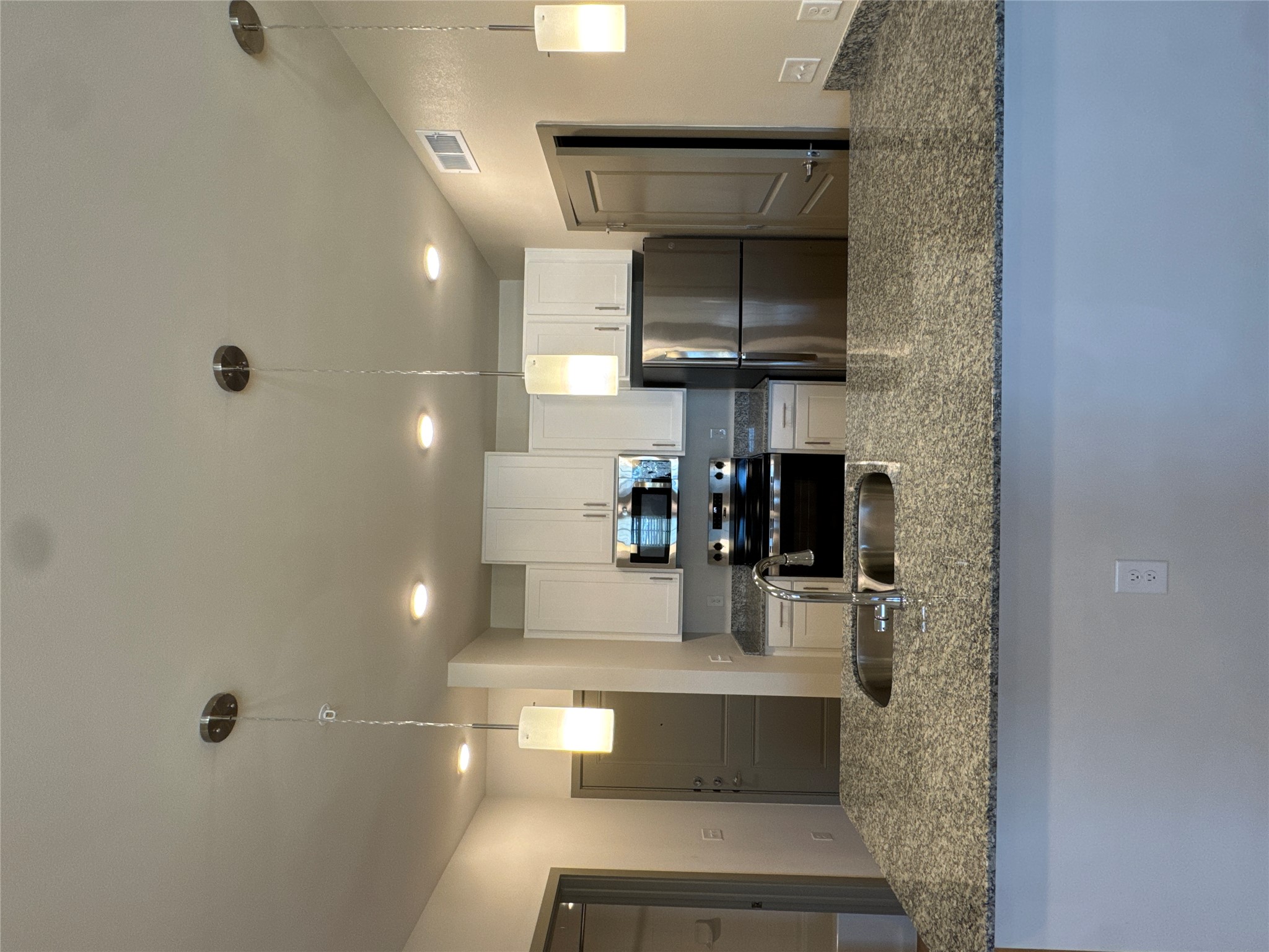 691 Union Chapel Road, Unit B2 Cedar Creek, TX 78612 - Photo 8 of 26 a kitchen with kitchen island a counter top space appliances and a sink