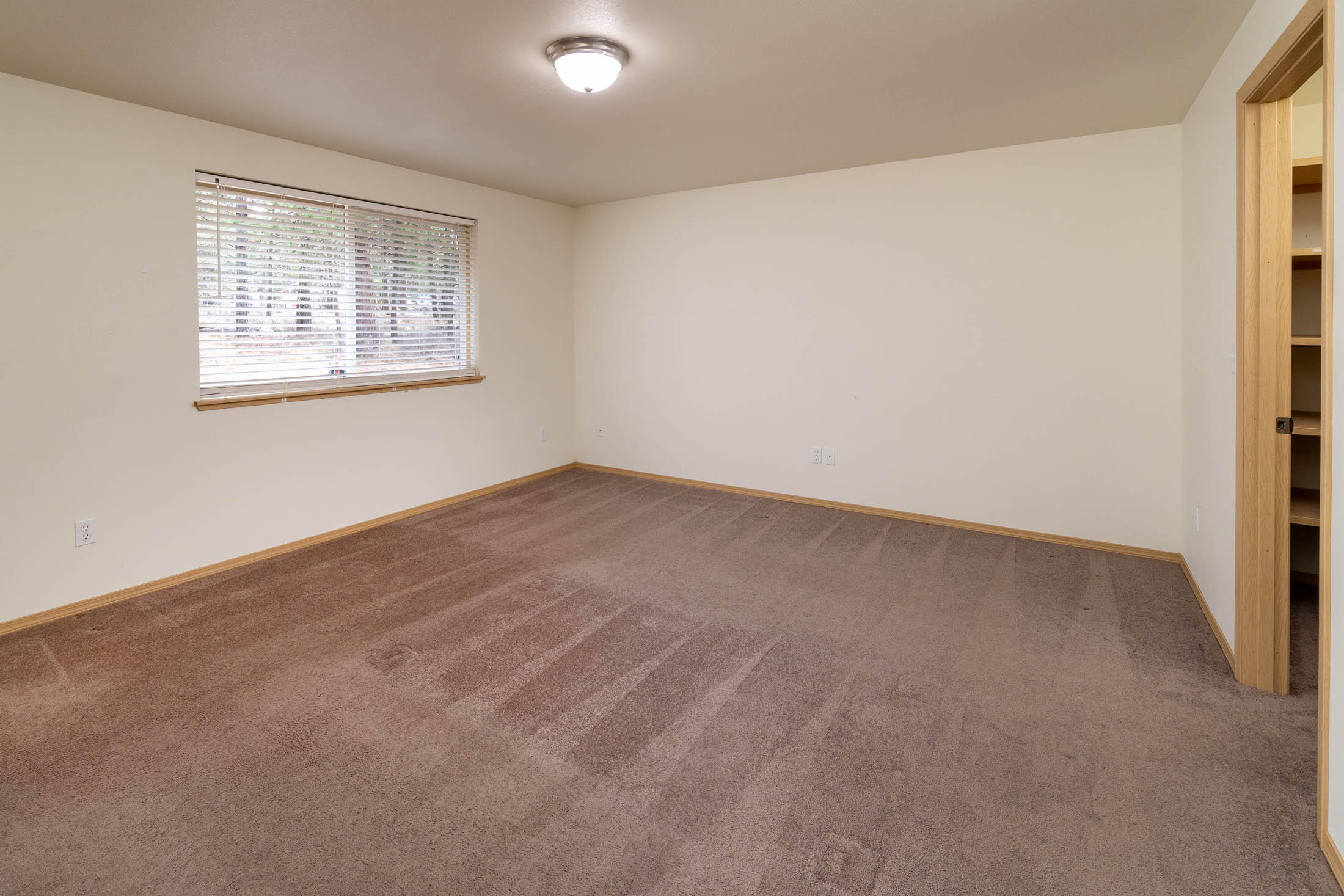 60196 Navajo Road Bend, OR 97702 - Photo 14 of 23 Primary bedroom with en-suite adjoining, and large walk-in closet with shelving.