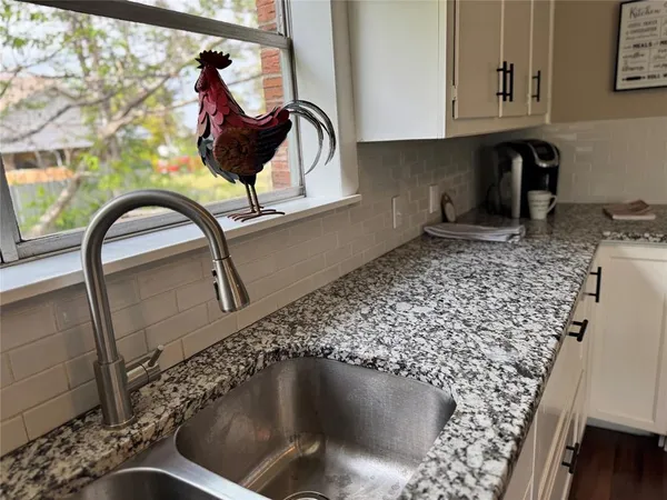 a kitchen with a table chairs stove and microwave