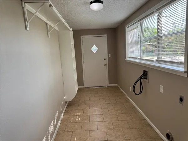a view of a workspace with wooden floor