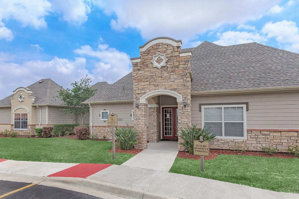 a front view of a house with a garden and plants