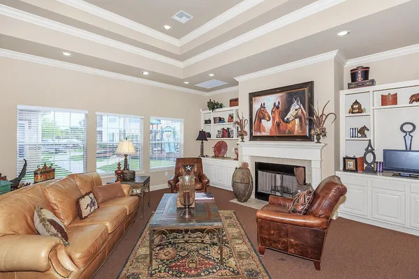 a living room with furniture fireplace and a large window