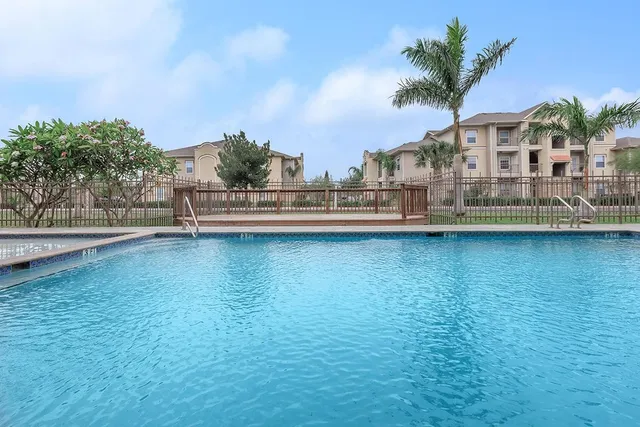 a view of a lake with house in the background