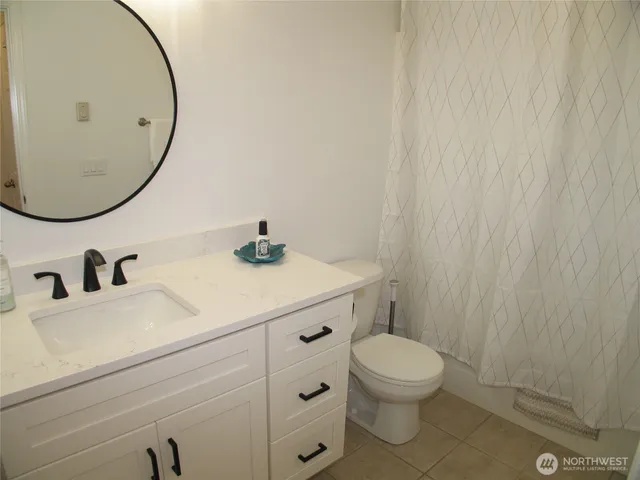 a bedroom with a bed and a dresser in it