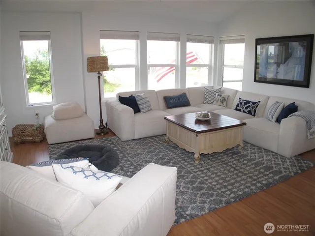 a kitchen with stainless steel appliances a stove a sink a microwave a refrigerator a stove and white cabinets