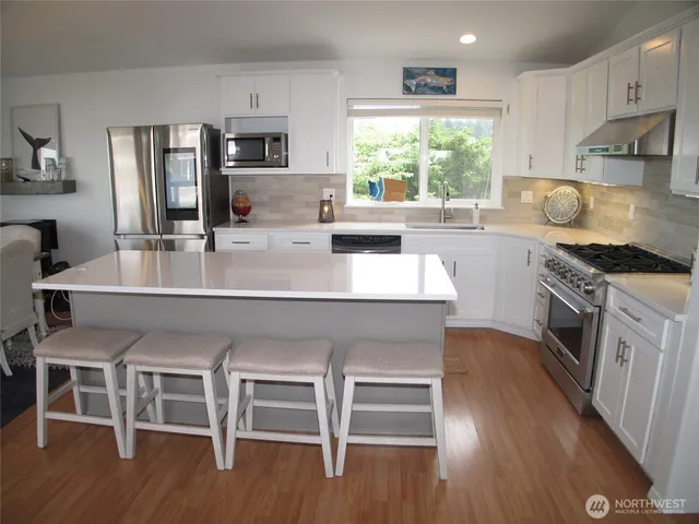 a large kitchen with a table and chairs