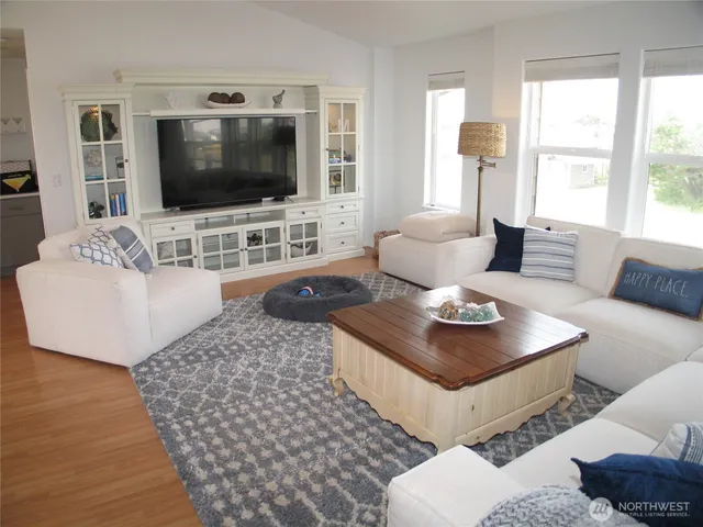a large white kitchen with a large window