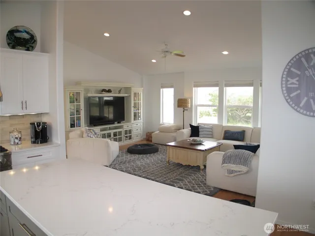 a living room with furniture and flowers