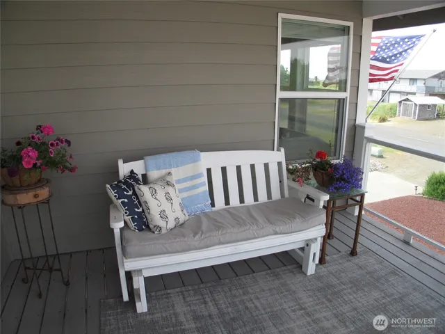 a view of a balcony with chair and wooden floor
