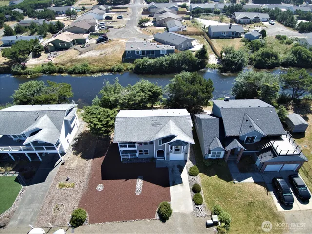 an aerial view of residential house with outdoor space and seating area