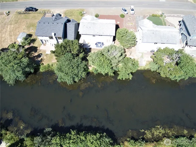 an aerial view of ocean with residential house