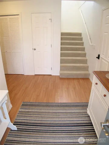 a large bed sitting in a bedroom next to a window