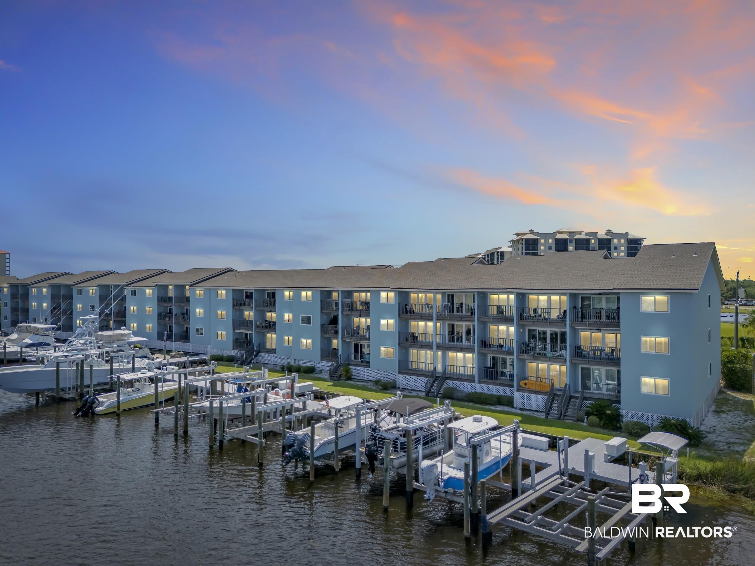 14100 River Road, Unit 211 Pensacola, FL 32507 - Photo 1 of 56 Waterfront multi-story building featuring private boat slips, individual balconies, and a coastal blue exterior